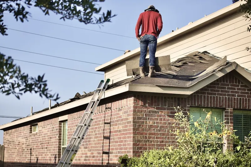 Professional roofer working on a residential roof in Wilbraham
